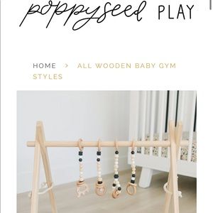 West Elm Poppyseed Play wooded play gym in natural pine with black toys